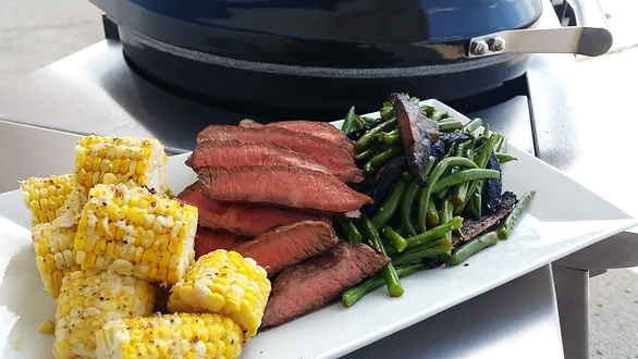 Steak, corn and Portobello mushrooms grilled with mayo